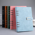 Lake-blue A5 notebook with U-shaped buckle, with alternative colours behind