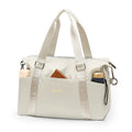Pale silver-grey gym travel bag with accessories shown for styling