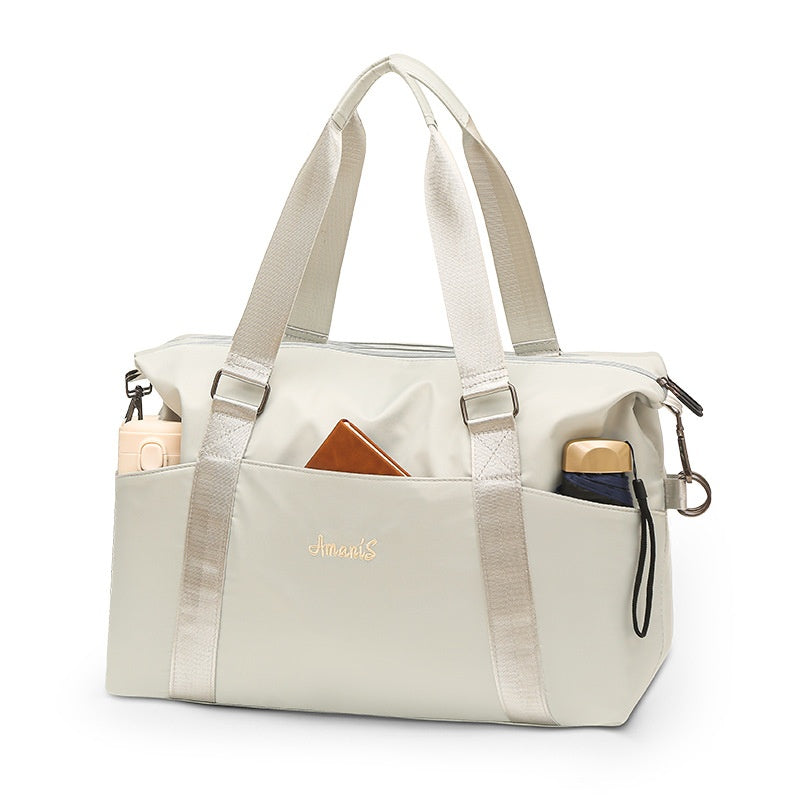 Pale silver-grey gym travel bag with accessories shown for styling