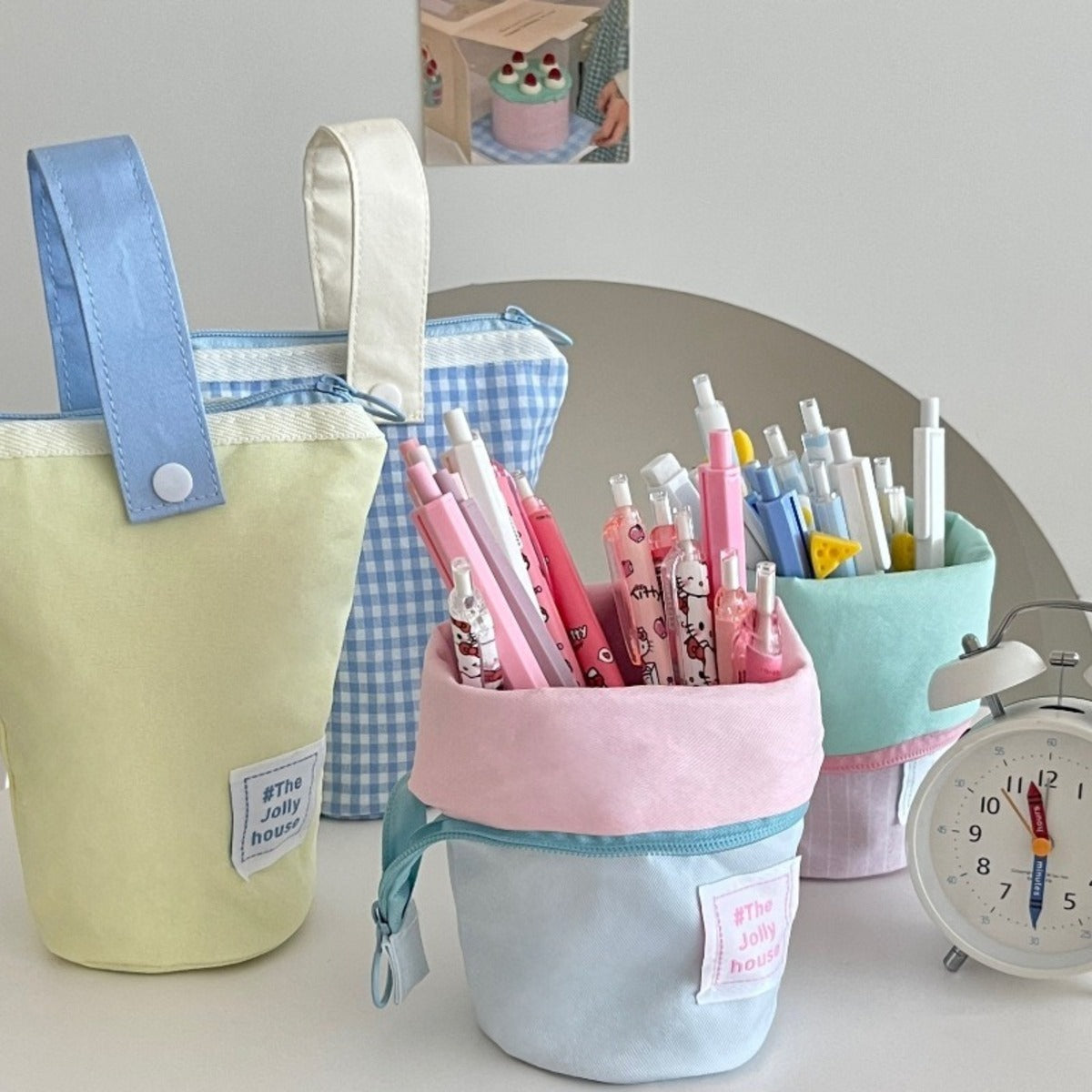 Pastel colour-block standing pencil cases with stationery shown for styling