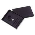 Dark card wallet with a round locator-holder recess, shown in presentation packaging; tracker excluded and packaging inclusion unverified