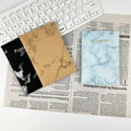 Marbled passport covers in brown, black and blue-white