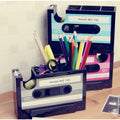 Cassette-shaped desktop organisers in assorted colours with stationery for styling