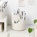 White rotating compartment pen holder with stationery shown for styling